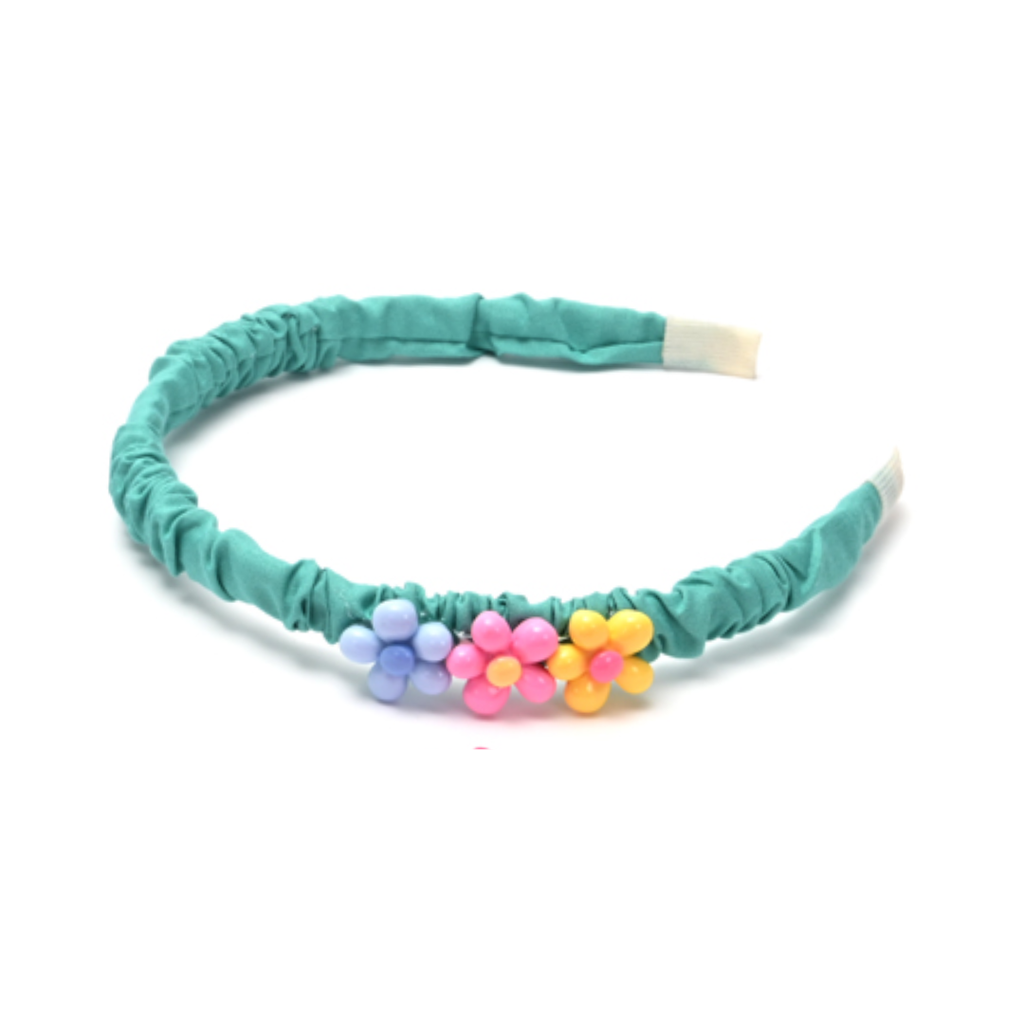 VINCHA CON APLIQUE DE FLORES COLOR LISO